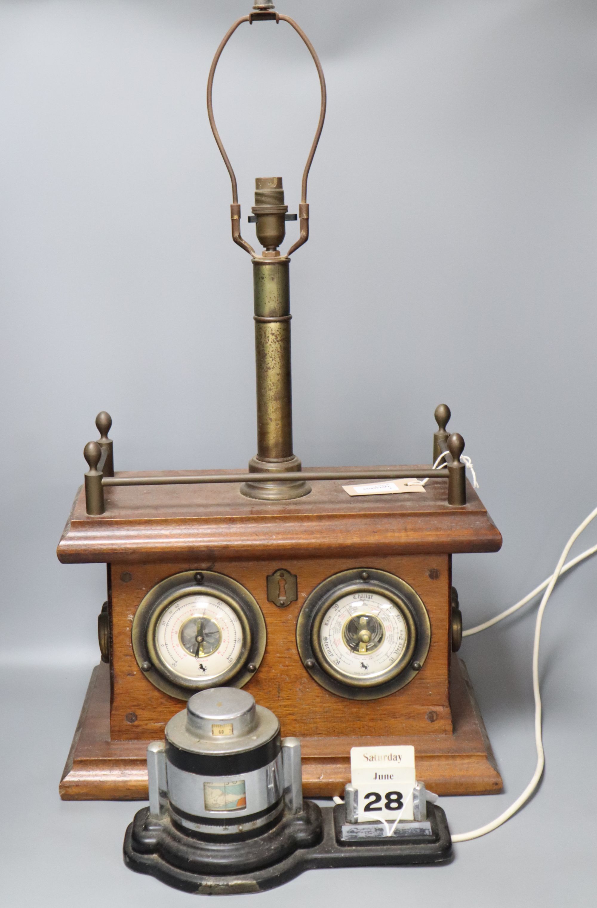 An Art Deco chromium desk calendar/barometer and a mahogany table lamp with thermometer and barometer dials